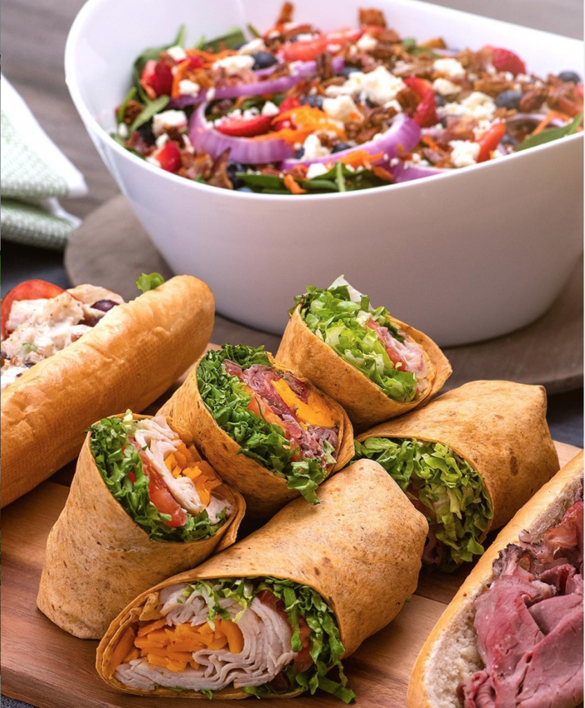 Catering order of sandwich wraps and a large salad bowl