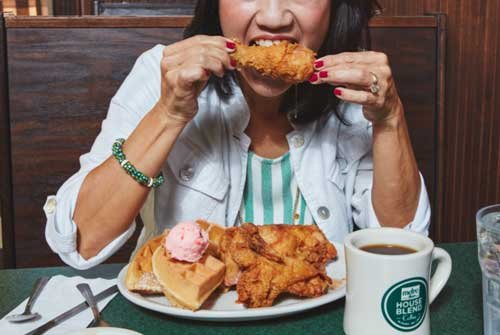 woman with fried chicken & waffle