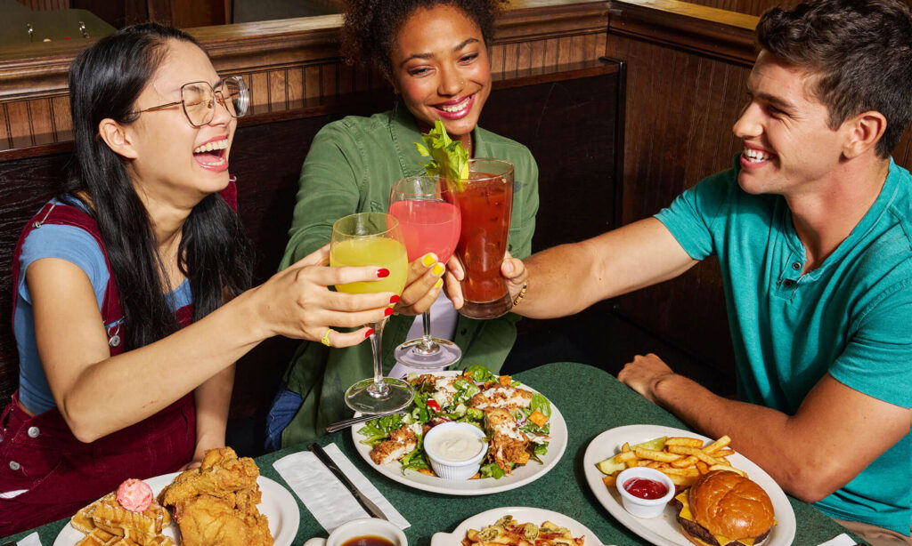 Brunch Cheers with salad burger and chicken and waffles